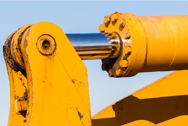 Sonderschrauben für Hydraulik Hydraulikzylinder mit Kolbenstange an einer Baumaschine – Symbolbild für Sonderschrauben der Stahlberg GmbH im Bereich Hydraulik.